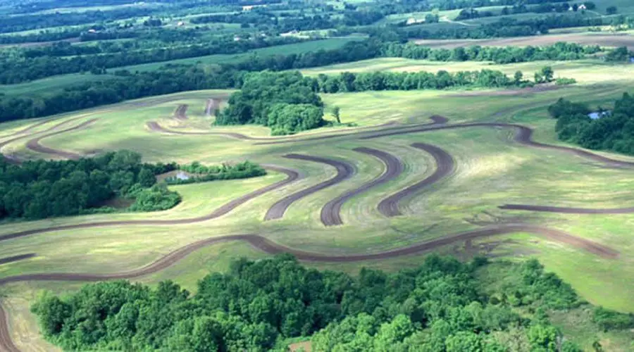 A dirt track with many curves in the middle of it.